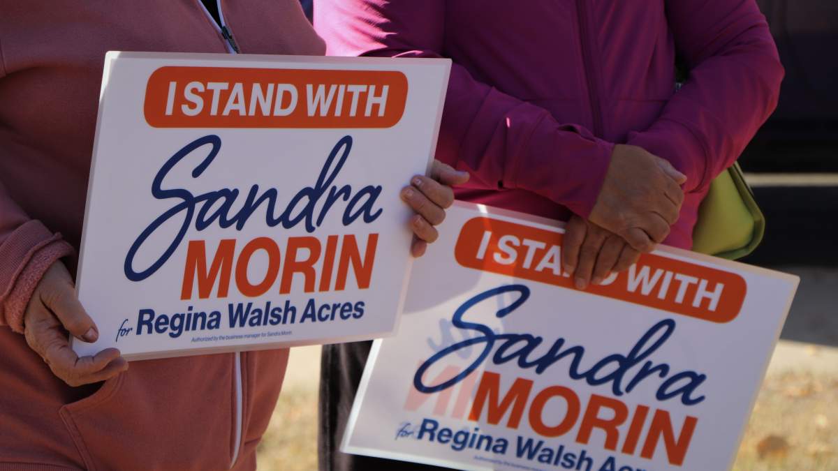 Supporters of Sandra Morin hold up ‘I Stand With Sandra Morin’ signs during her campaign announcement, Friday, Sept. 25, 2020.