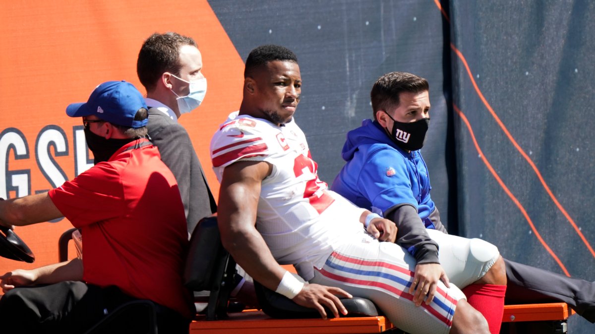 New York Giants running back Saquon Barkley (26) is carted to the locker room after being injured during the first half of an NFL football game against the Chicago Bears in Chicago, Sunday, Sept. 20, 2020.