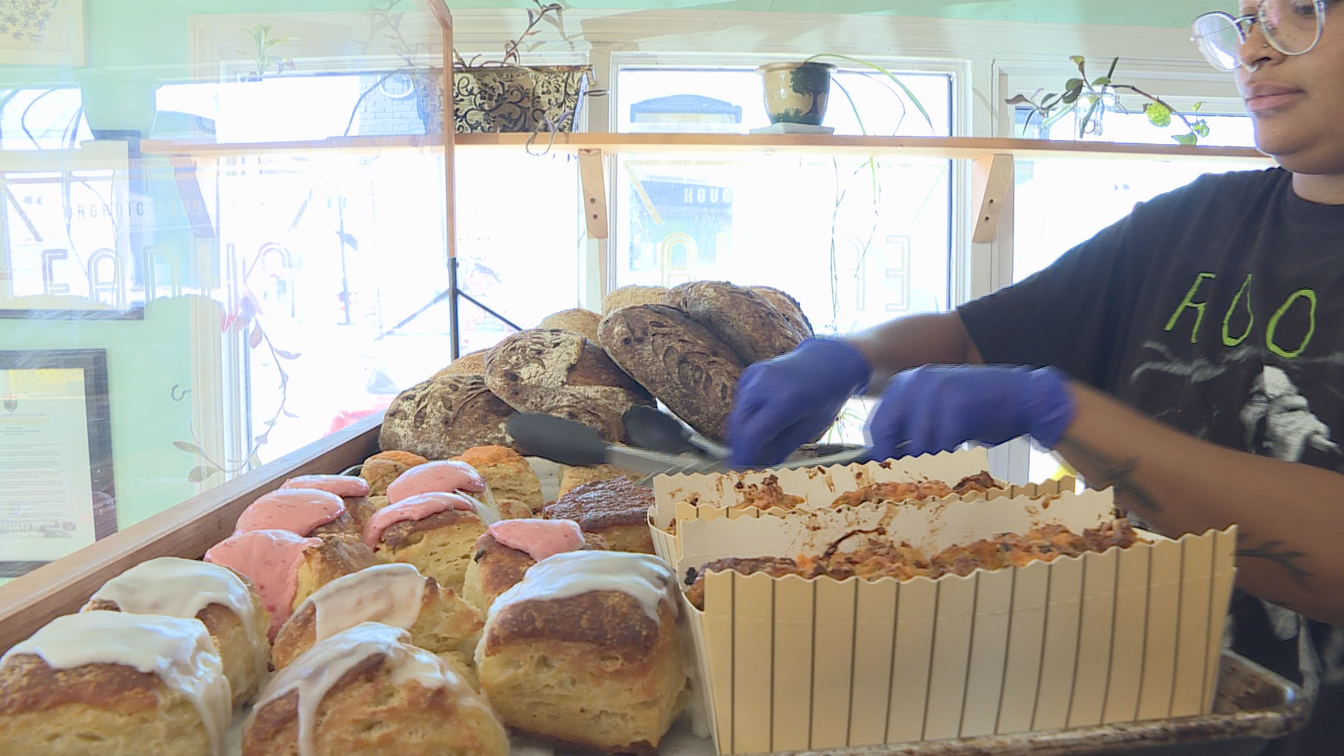 Tamika Krush, an employee at the bakery rearranges, the store’s front display.