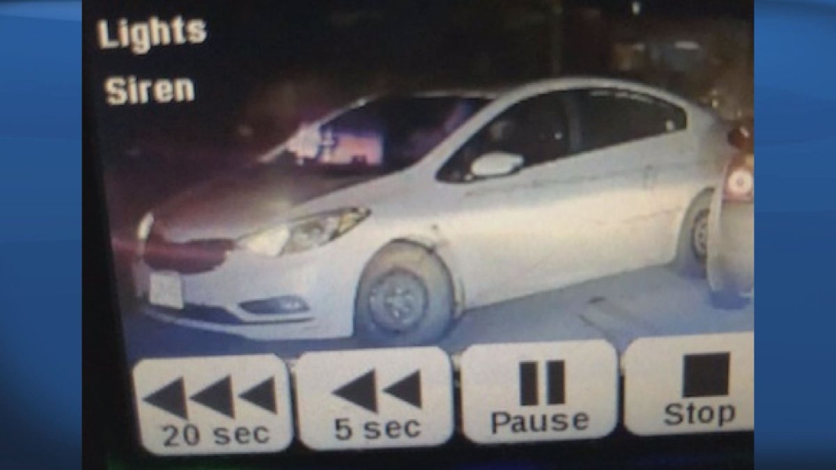 Image captured on the RCMP cruiser camera which shows the stolen white Kia Forte backing into another passenger vehicle.