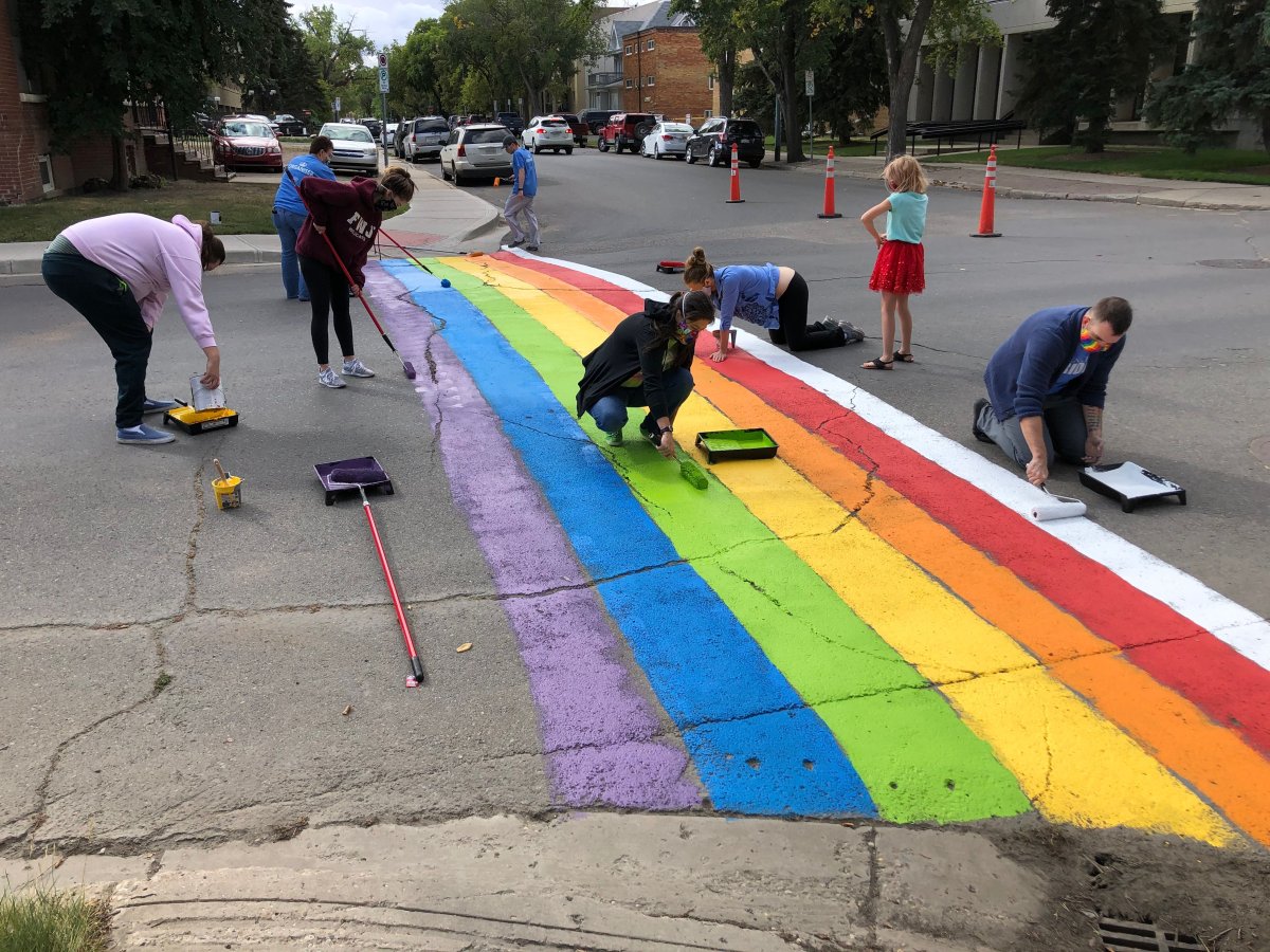 Volunteers paint a rainbow flag on 13th Avenue at Cornwall Street on Sunday, Sept. 6. 