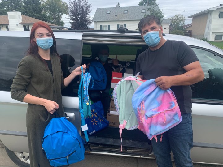 Edmonton duo hands out backpacks full of school supplies to families in