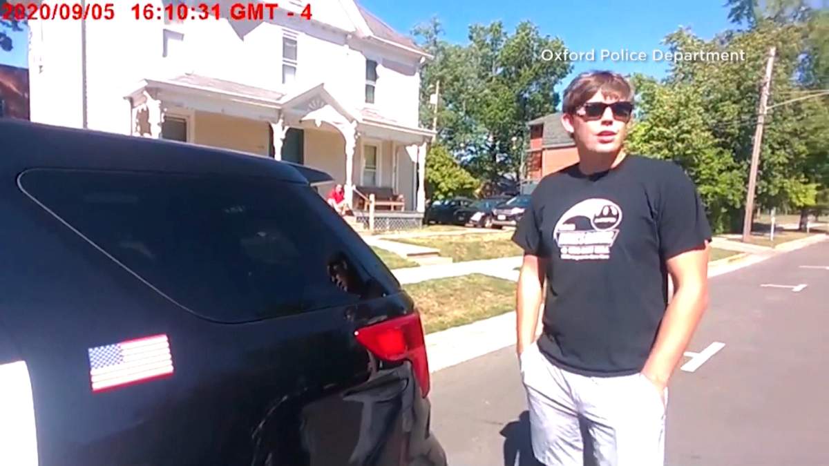 One of the hosts of the party talks to a police officer.