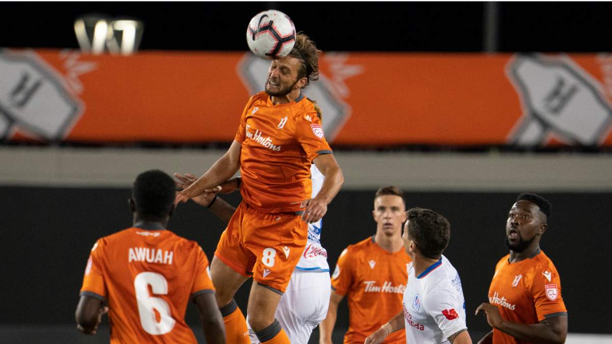 Hamilton Forge FC's Giuliano Frano (8) heads the ball against CD Olimpia's Jorge Benguche (9) during Scotiabank CONCACAF League 2019 second half soccer action in Hamilton on Thursday, August 22, 2019. 