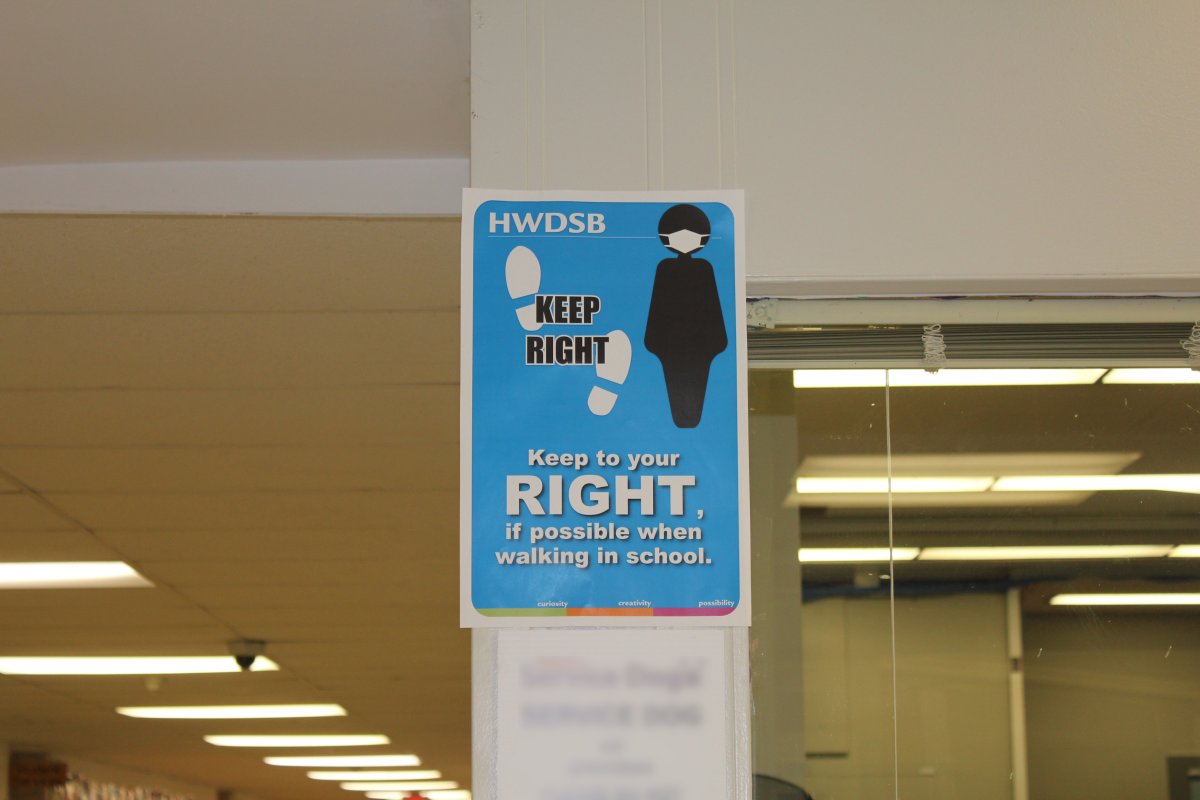 One of many physical distancing signs posted inside Ancaster secondary school in Hamilton. 