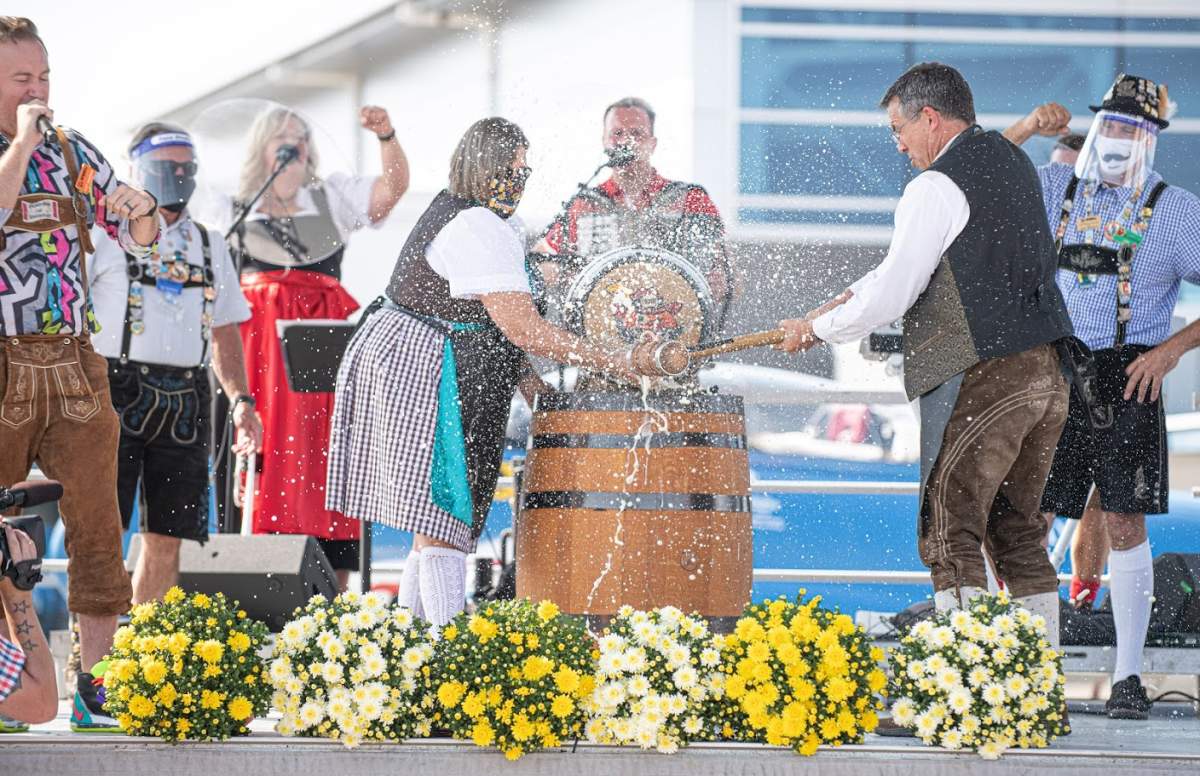 Tim and Kathy Beckett tap the Oktoberfest keg at the Waterloo International Airport.