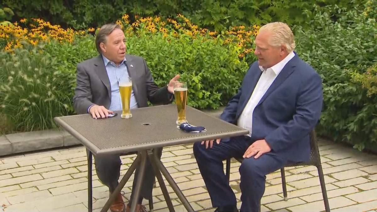 Ontario Premier Doug Ford (front) and Quebec Premier François Legualt sip beer in Toronto. Legault is in Ontario for a two-day summit hosted by Ford to discuss how the two provinces can work together to rebuild their economies. Tuesday, Sep. 8, 2020.