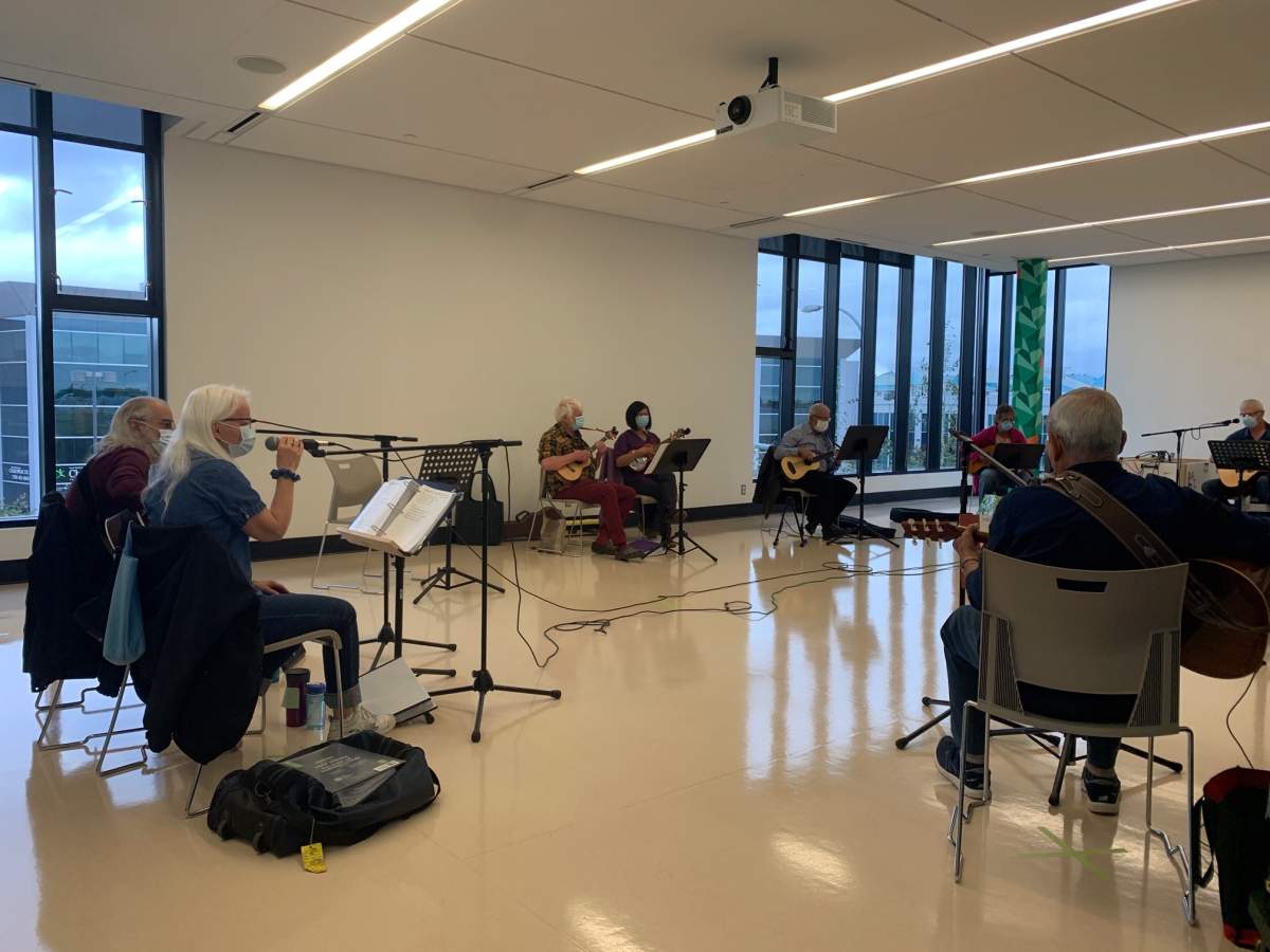 Seniors singing while wearing masks and distancing.