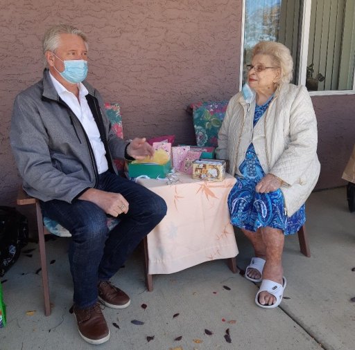 Gord Steinke with Micheline Gomez, 90, who is making cards during the pandemic. Oct. 2020.