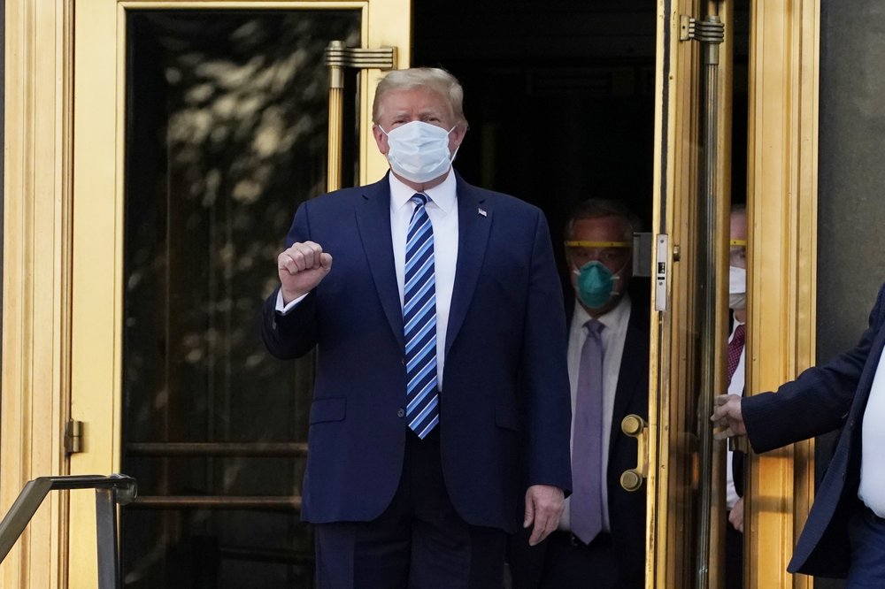 President Donald Trump walks out of Walter Reed National Military Medical Center to return to the White House after receiving treatments for COVID-19, Monday, Oct. 5, 2020, in Bethesda, Md.