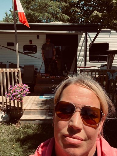 Lawson and his wife Christie standing more than six feet apart from one another at their trailer on Lake Dalrymple, the place Lawson quarantined at after testing positive for the novel coronavirus. 