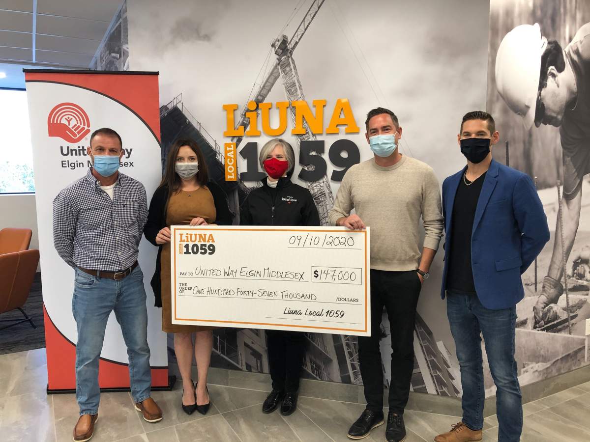 LiUNA Local 1059 business manager Brandon MacKinnon (second from right) is joined by fellow LiUNA members during a cheque presentation to United Way's director of development Jennepher Cahill (centre).