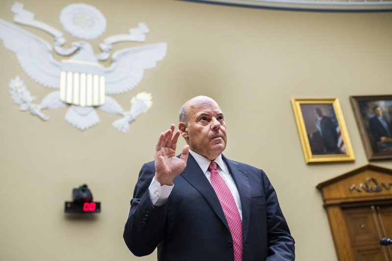 FILE - In this Monday, Aug. 24, 2020, file photo, Postmaster General Louis DeJoy is sworn in before testifying during a House Oversight and Reform Committee hearing on the Postal Service on Capitol Hill in Washington. The U.S. Postal Service agreed Wednesday, Oct. 14, to reverse changes that slowed mail service nationwide, settling a lawsuit filed by Montana Gov. Steve Bullock during a pandemic that is expected to force many more people to vote by mail. 