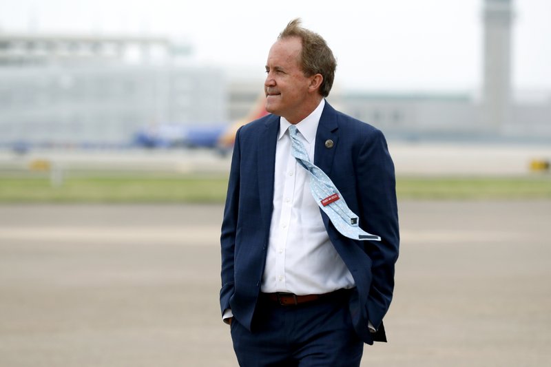 FILE - State Attorney General Ken Paxton waits on the flight line for the arrival of Vice President Mike Pence at Love Field in Dallas, Sunday, June 28, 2020. Several top deputies of Texas’ attorney general have accused him of crimes including bribery and abuse of office in an internal letter saying they’ve reported the actions to law enforcement. In a brief letter, seven senior lawyers wrote that they reported Paxton for potentially breaking the law “in his official capacity as the current Attorney General of Texas." Paxton’s defense attorney in the securities case, declined to comment on the new allegations Sunday, Oct. 4, 2020. Paxton pleaded not guilty in that case but it is not clear whether the new .