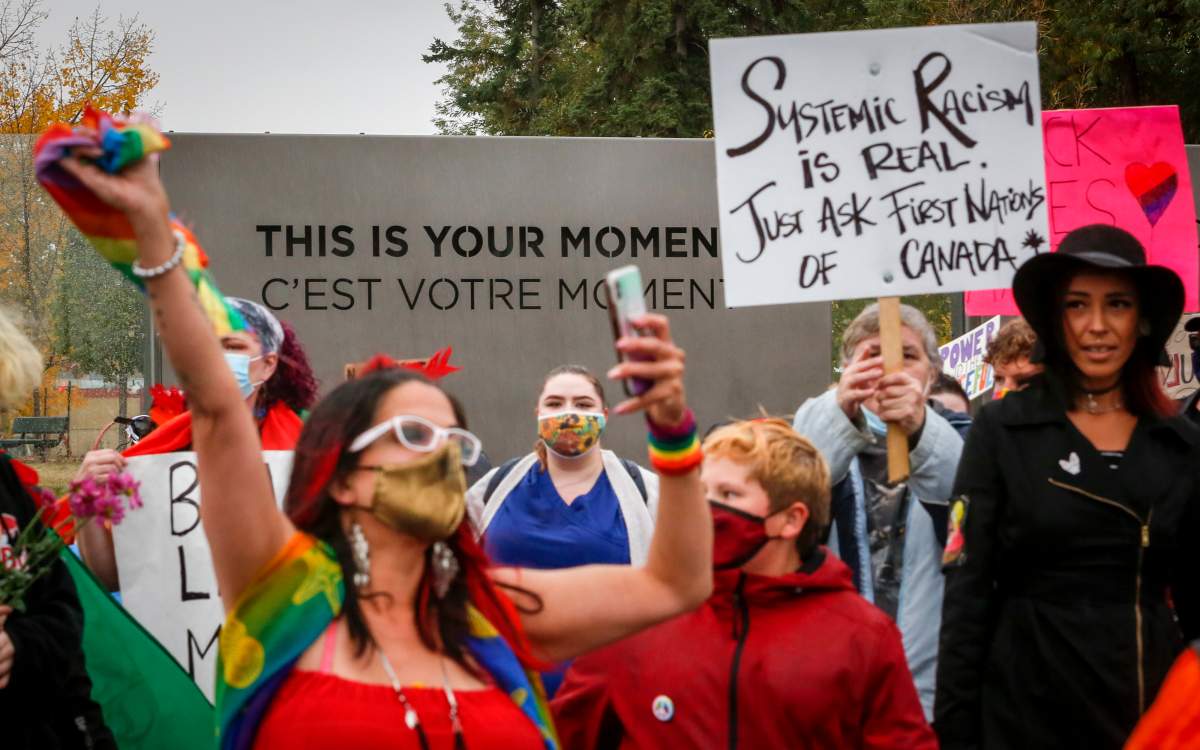 Demonstrators march during an anti-racism event in Red Deer, Alta., Sunday, Oct. 4, 2020.
