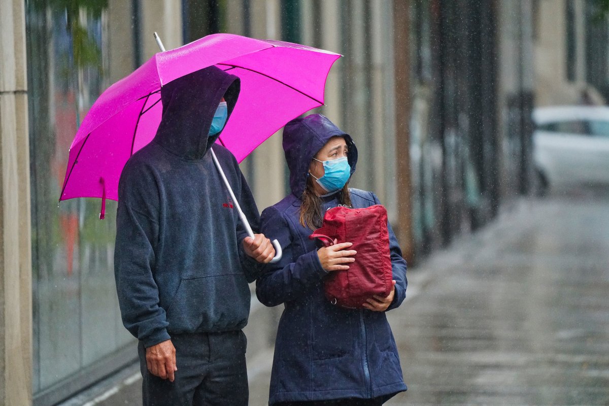 Couple wearing a face masks waiting to cross the street in Montreal, Que., Tuesday, October 13, 2020.