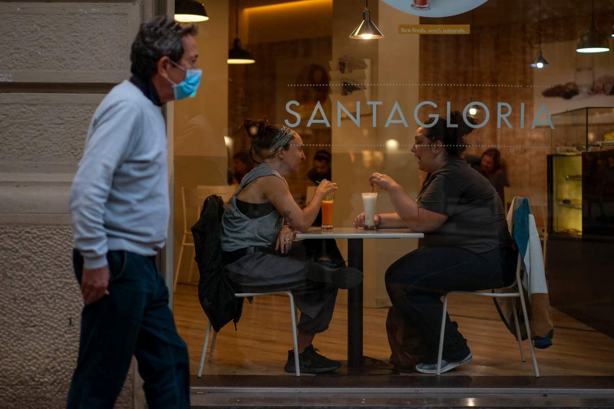 Customers sit inside a bar in Barcelona, Spain, Thursday Oct. 15, 2020.