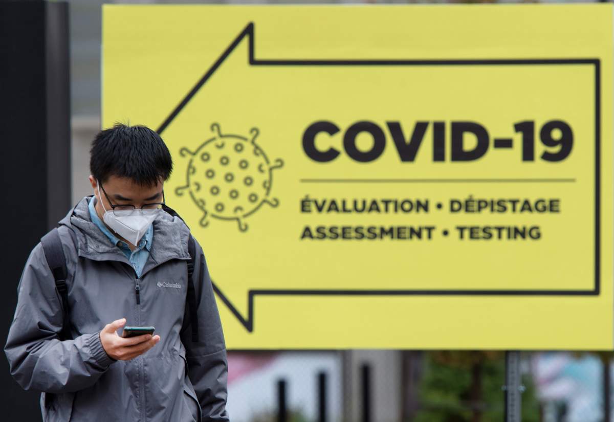A passer-by walked past a COVID-19 testing clinic in Montreal, Friday, Oct. 16, 2020.