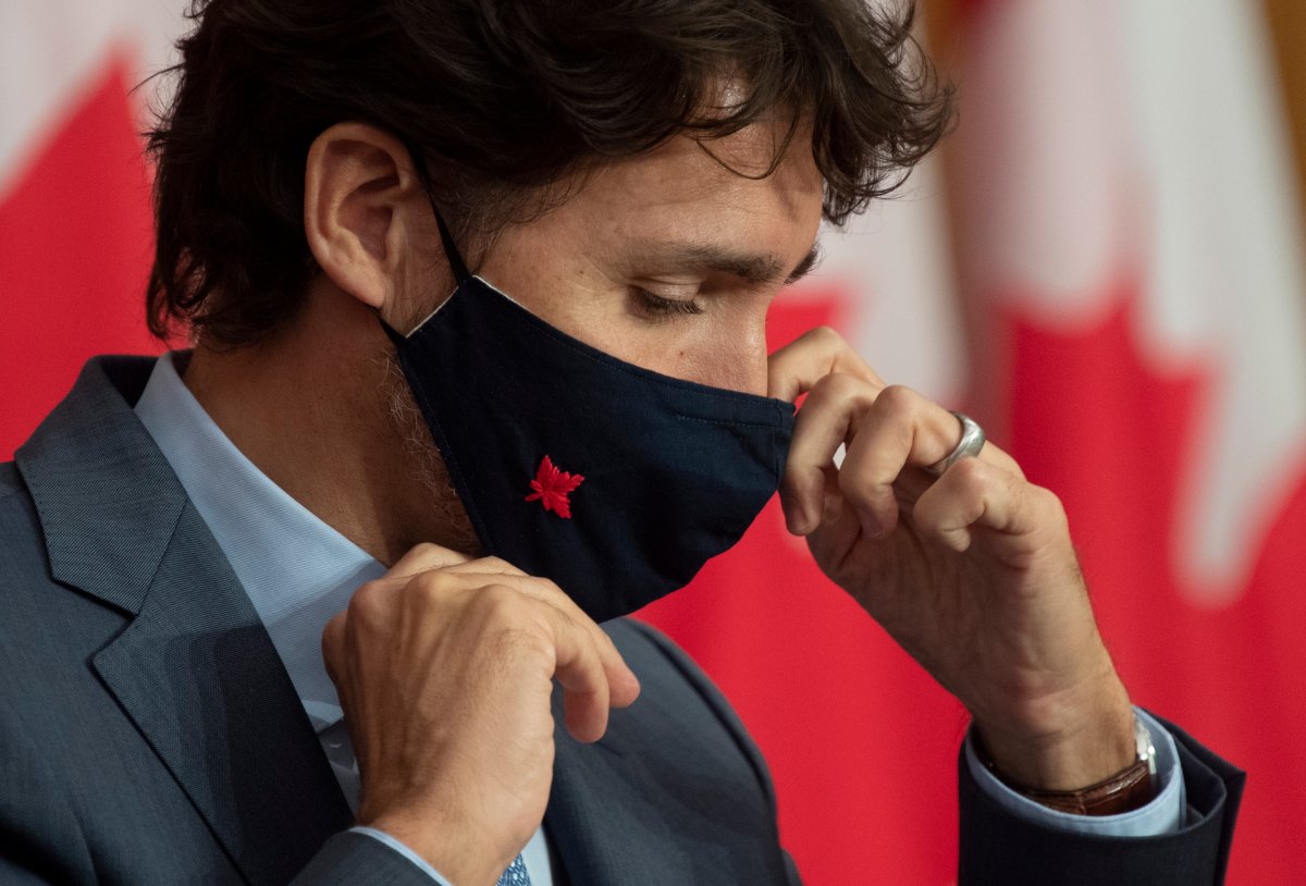 Prime Minister Justin Trudeau adjusts his mask as he leaves a news conference Tuesday October 20, 2020 in Ottawa.