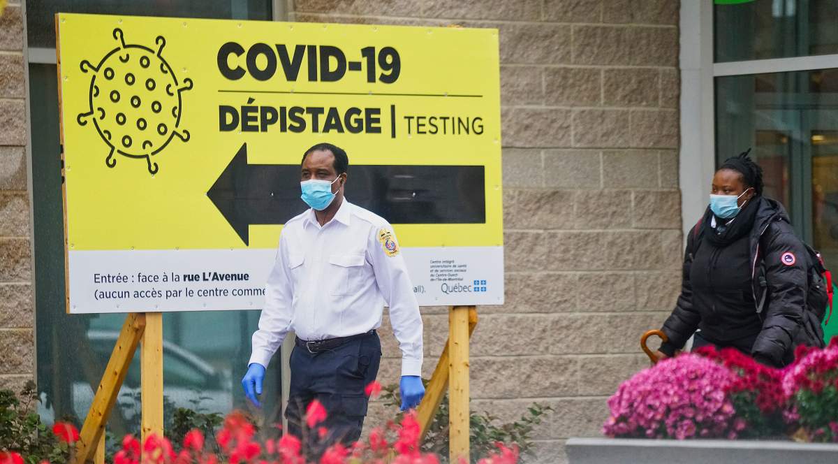 Security guard leading the way to a COVID-19 testing clinic in Montreal, Que., Wednesday,  October 21, 2020. 