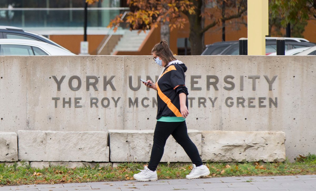 TORONTO, Oct. 20, 2020 A student wearing a face mask walks at York University in Toronto, Canada, on Oct. 20, 2020.