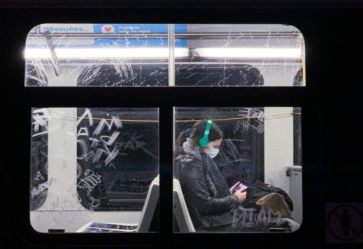 A woman wears a face mask as she commutes on a city bus in Montreal, Monday, Oct. 19, 2020, as the COVID-19 pandemic continues in Canada and around the world.