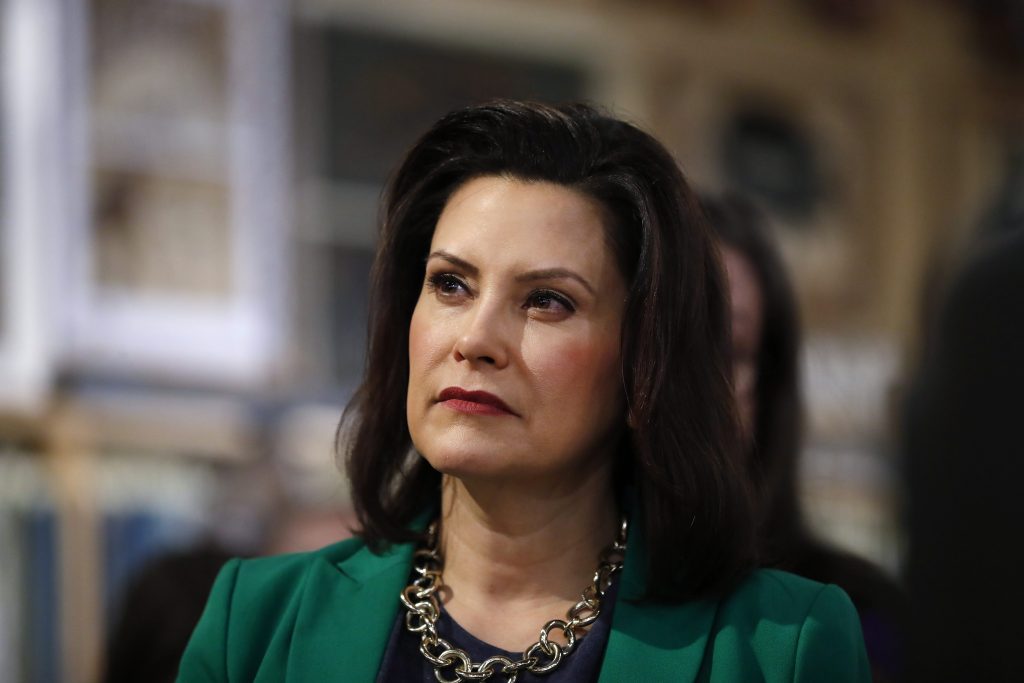 FILE--In this March 18, 2019, file photo, Michigan Governor Gretchen Whitmer listens to Democratic presidential candidate Sen. Kirsten Gillibrand, D-N.Y., in Clawson, Mich. Whitmer is directing Michigan's environmental agency to develop drinking water standards for certain toxic industrial chemicals rather than waiting for updated federal guidelines. The rules will cover long-lasting "forever" chemicals known as perfluoroalkyl and polyfluoroalkyl substances, or PFAS, which were long used in firefighting, waterproofing, carpeting and other products. The Democrats says she will not wait for the Trump administration to act.