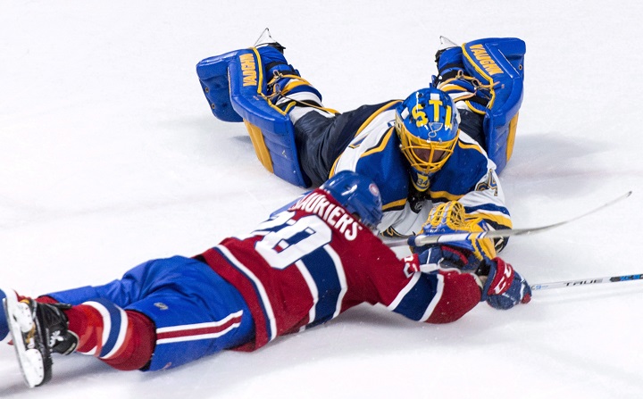 In this 2017 file photo, former St. Louis Blues goalie Jake Allen and Montreal Canadiens' Nicolas Deslauriers dive for the puck during NHL hockey action in Montreal. Allen signed a two-year contract extension with the Habs worth US US$2.875 million per season. Wednesday, Oct. 14, 2020.