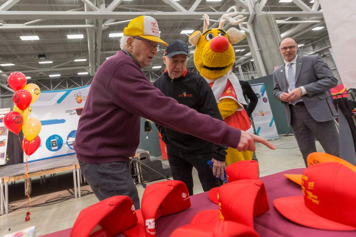 Claude Albert, left, and Operation Nez rouge founder Jean-Marie De Koninck look at memorabilia before leaving the headquarter in Quebec City on Dec. 13, 2018. 