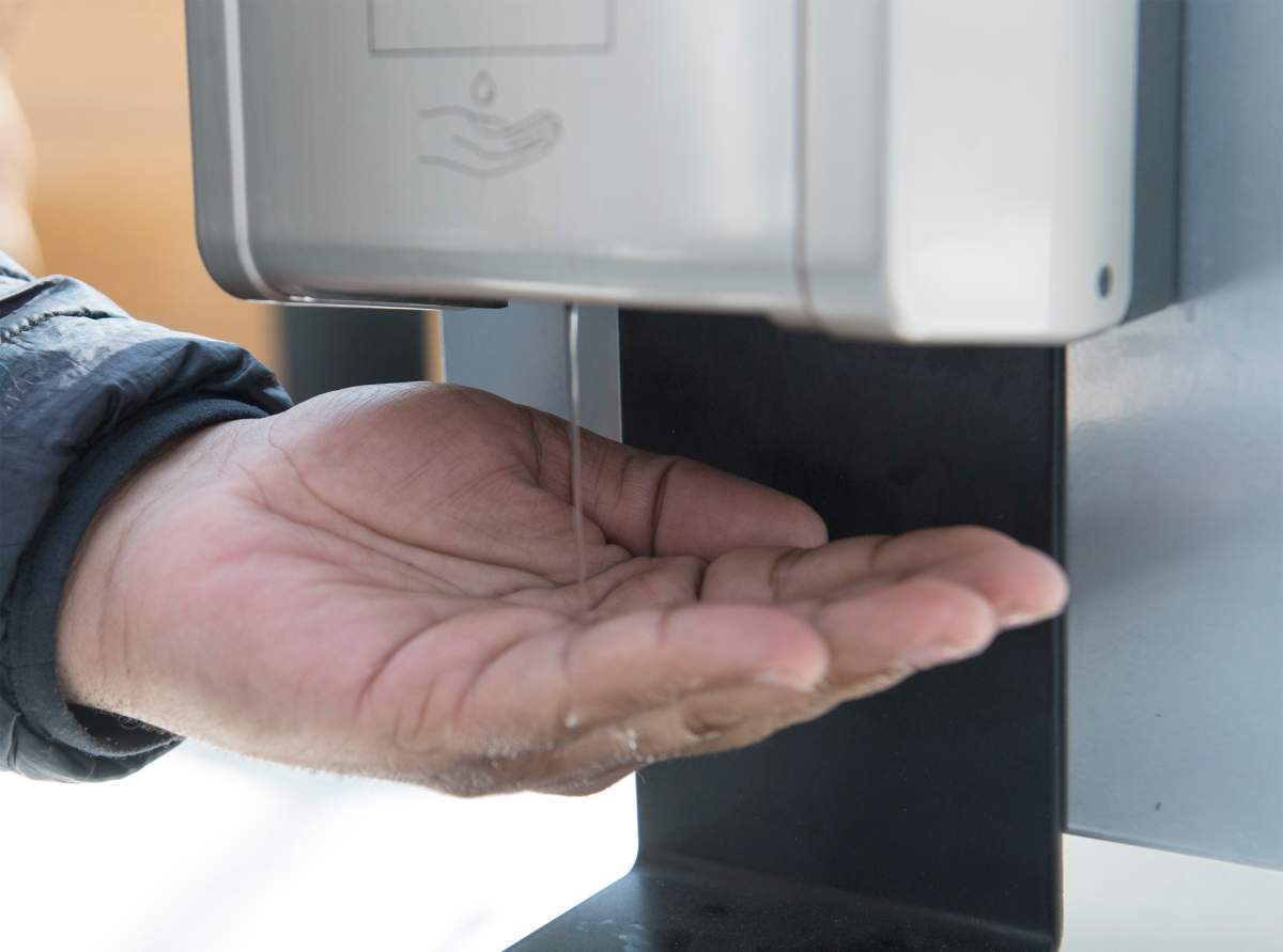 A man dispenses hand sanitizer in a shopping mall in the Montreal borough of Pointe-Claire, Saturday, March 14, 2020.