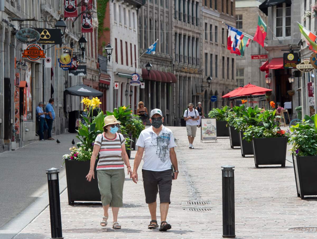 People walk through Old Montreal, Wednesday, July 22, 2020. 