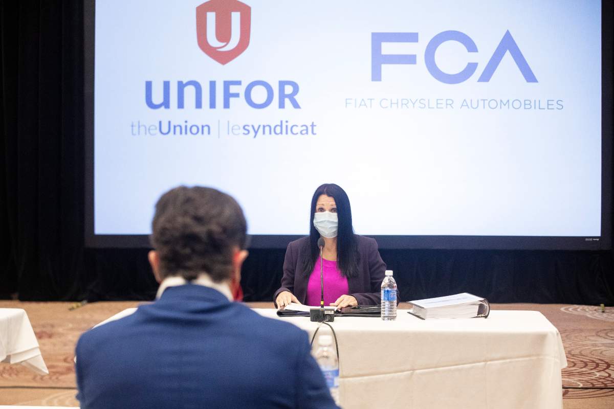 Jacqueline Oliva, head of human resources for Fiat Chrysler Automobiles (FCA) Canada, sits opposite Jerry Dias, President of the Unifor union, at the start of formal contract talks with the Detroit Three automakers, Fiat Chrysler, Ford and General Motors, in Toronto, Wednesday, Aug. 12, 2020.