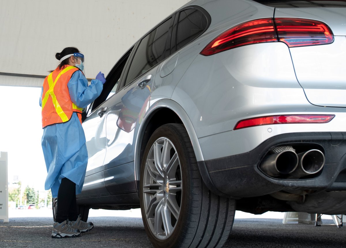 Ottawa Health personnel speaks with the driver before administering a COVID-19 test at a drive-through test centre in Ottawa, Friday, September 4, 2020. The Coventry testing site is one of the few places in Ottawa to get a test on Monday, Oct. 5, 2020.