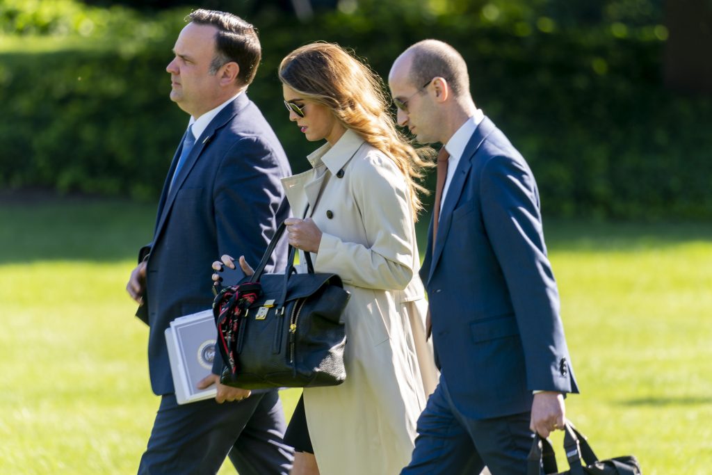 From left, White House Social Media Director Dan Scavino, Counselor to the President Hope Hicks, and President Donald Trump\’s White House senior adviser Stephen Miller, walk across the South Lawn to board Marine One on the South Lawn of the White House in Washington, Monday, Sept. 21, 2020, for a short trip to Andrews Air Force Base, Md., and then on to Ohio for rallies with President Donald Trump.