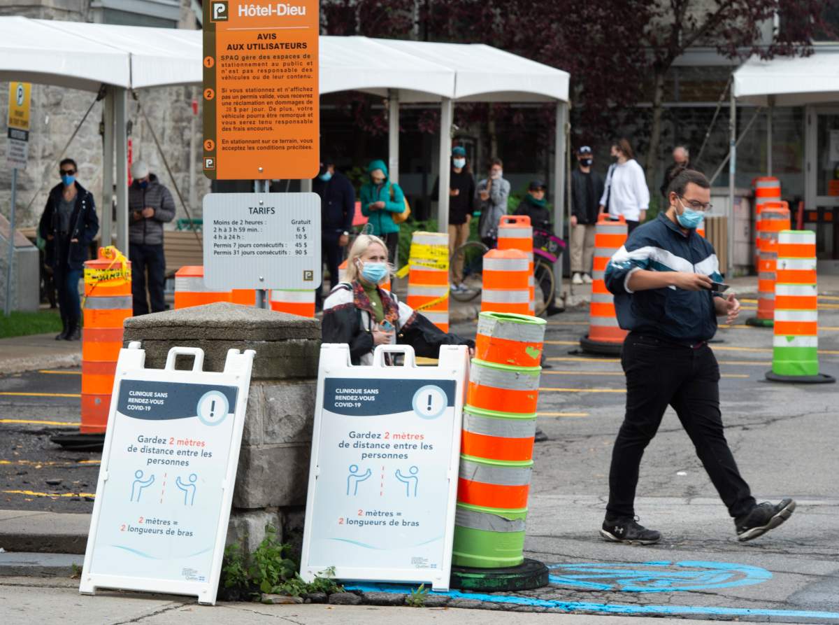 People line up at a COVID-19 testing center Wednesday, September 30, 2020  in Montreal.The Quebec government is upgrading the COVID-19 alert level to red in the Montreal area as of midnight.THE CANADIAN PRESS/Ryan Remiorz.