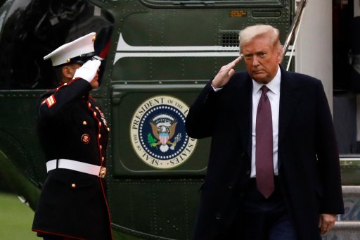 U.S. President Donald Trump salutes from the steps of Marine One helicopter on the South Lawn of the White House upon his return to Washington from Bedminster, New Jersey on October 1, 2020.