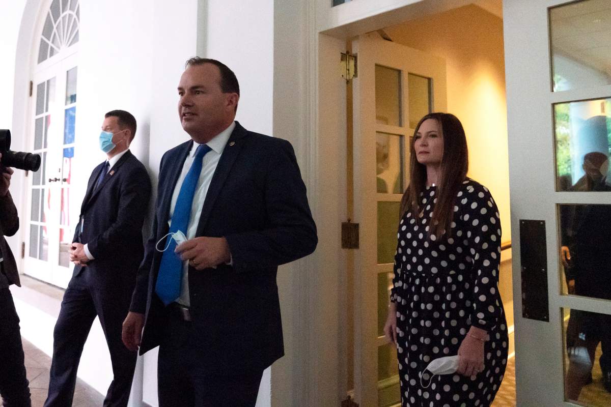 In this Saturday, Sept. 26, 2020, photo, Sen. Mike Lee, R-Utah, center, steps out of the West Wing to watch as President Donald Trump announces Judge Amy Coney Barrett as his nominee to the Supreme Court, in the Rose Garden at the White House in Washington.