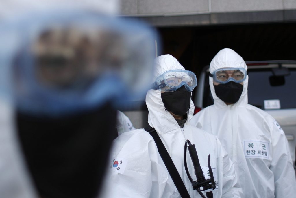 South Korean soldiers wearing protective gears prepare to spray disinfectant as a precaution against the new coronavirus on a street in Seoul, South Korea, Friday, March 6, 2020. 