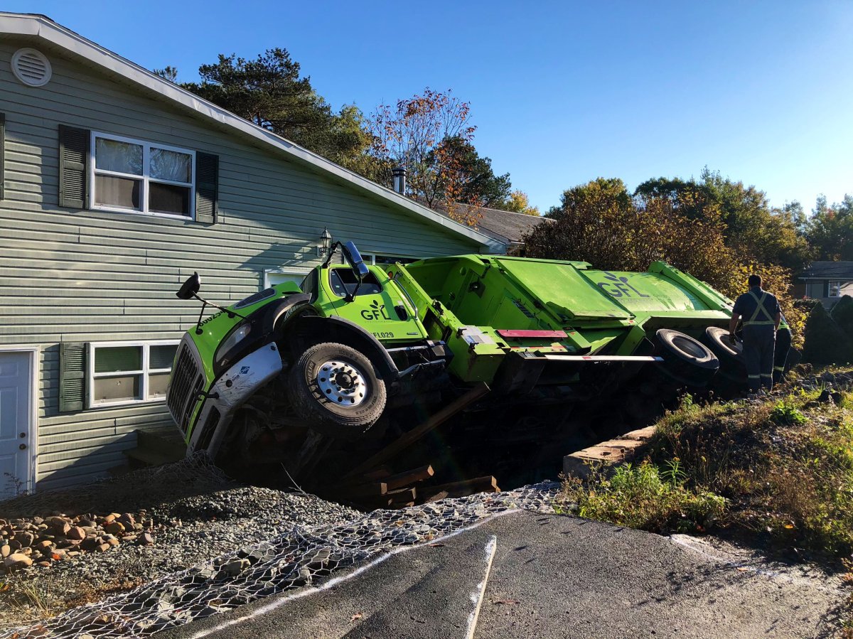 A dump truck turned over on its side in Lower Sackville, N.S., on Oct. 15, 2020. 