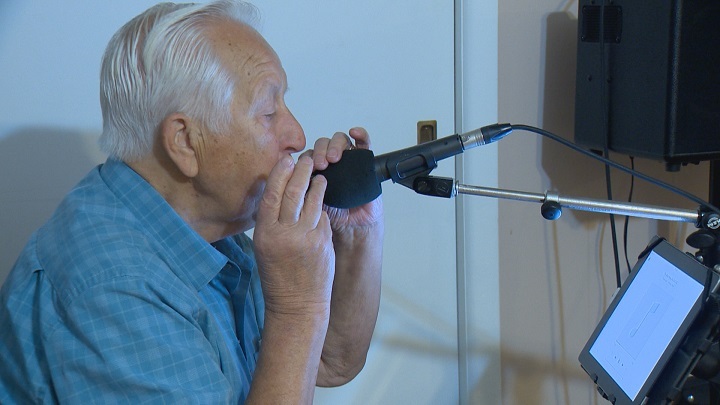 Floyd Barto plays his harmonica. Barto has been posting videos of himself playing to Facebook and YouTube for others to enjoy.