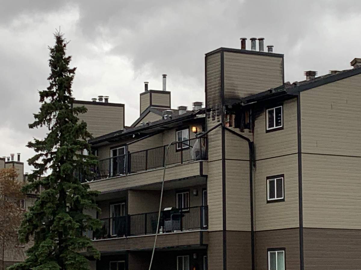 Edmonton firefighters battle a blaze at an apartment building in the area of 40 Street and 26 Avenue Tuesday, Oct. 27, 2020.