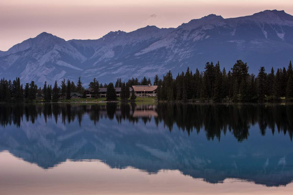 The Fairmont Jasper Park Lodge is viewed across Beauvert Lake before sunrise on June 25, 2013 near Jasper, Alberta, Canada.