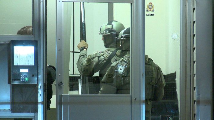 A couple of bullet holes could be seen in the front door of the Edmonton walkup apartment complex at 96 Street and 129B Avenue on Sunday. 