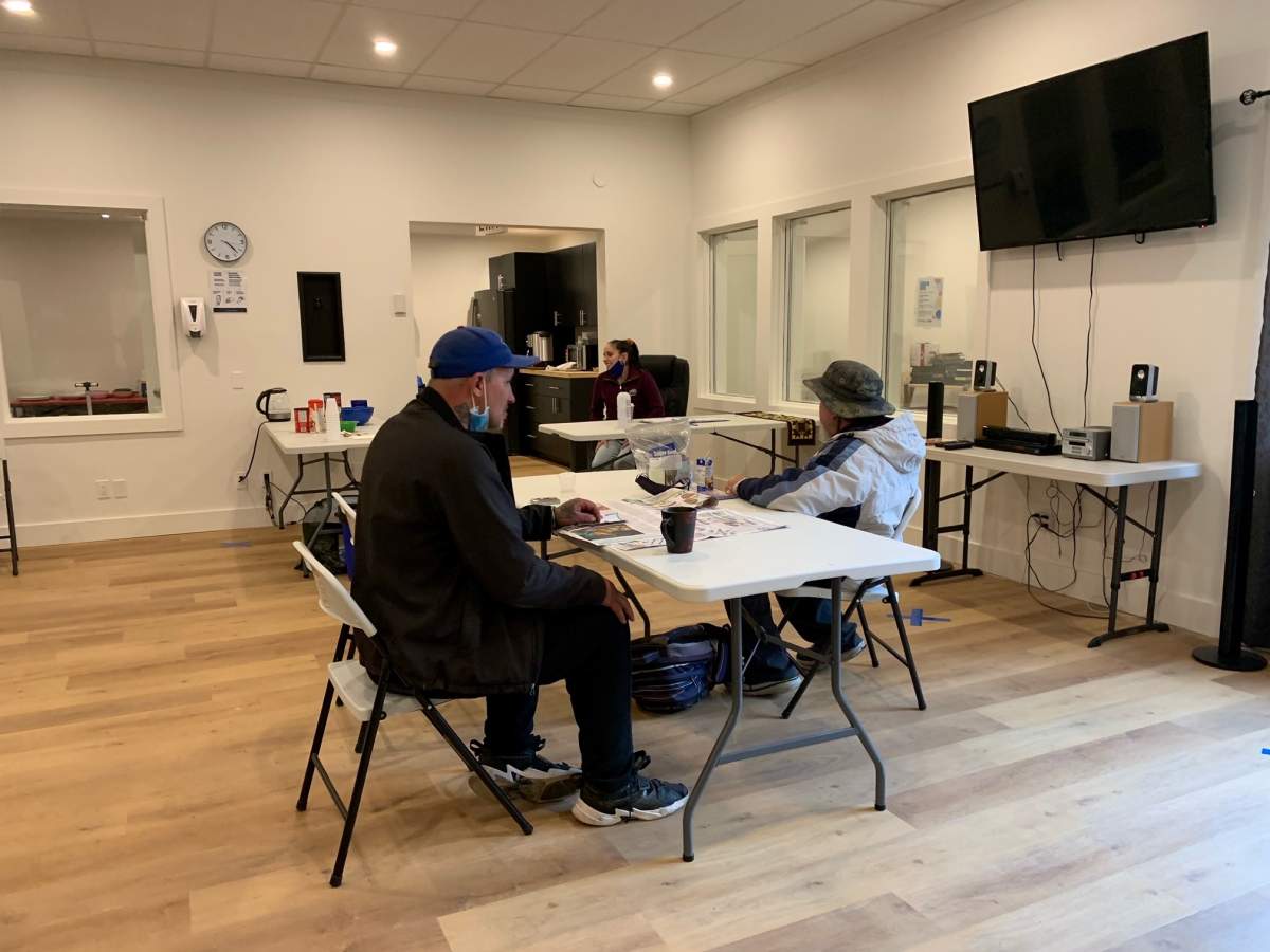 Two residents sit for a cup of coffee at the new Phoenix Learning Centre in Fredericton, N.B.