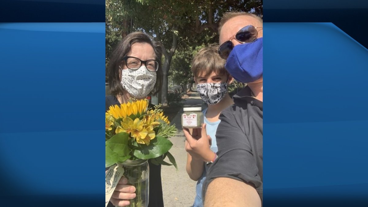 Chad Richardson, right, is shown in this group selfie after picking up a jar of Newfoundland savoury from Tina Cornejo, left, in this recent handout photo. 