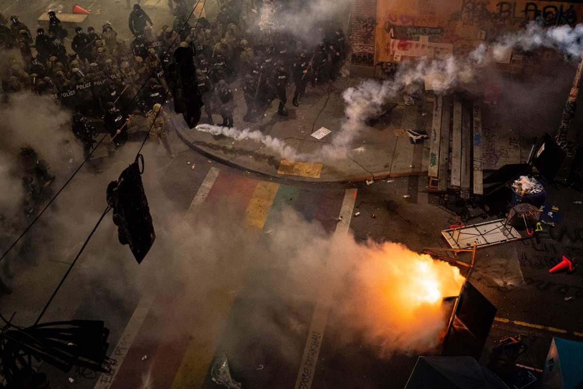 Police and demonstrators clash in Seattle, Wash., on June 8, 2020 during a Black Lives Matter protest. A senior security source said intelligence agencies will monitor the state of Washington for signs of far-right extremist activity linked to the U.S. election.