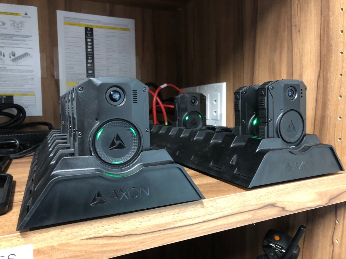 Body cameras sit docked in a charging station at St. Thomas police headquarters.