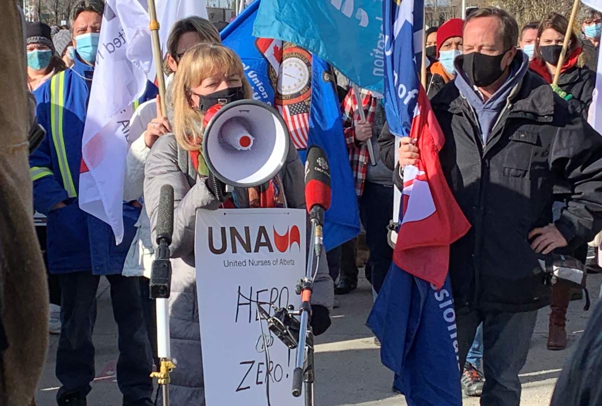 United Nurses of Alberta (UNA) president Heather Smith (middle) and Health Sciences Association of Alberta (HSAA) president Mike Parker (right) speak at the AUPE picket line outside the Royal Alexandra Hospital on Monday, October 26, 2020.