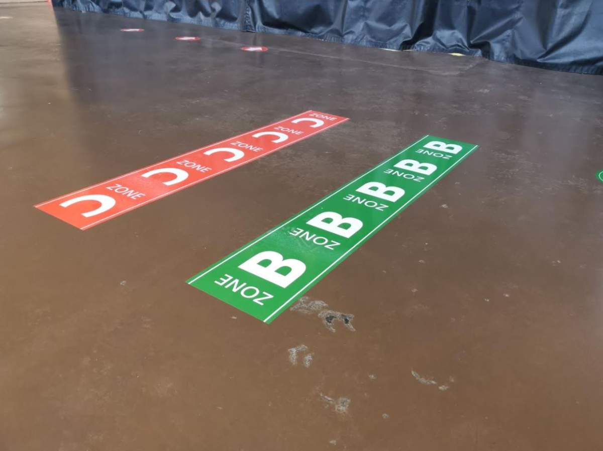 These signs on the floor show what zones fan should be staying in.