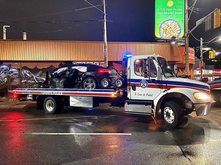 Police towing away the badly damaged car following a crash at Lansdowne Avenue and College Street.